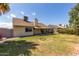 Expansive backyard with a covered patio and lush green grass under a clear blue sky at 7302 W Meadowbrook Ave, Phoenix, AZ 85033
