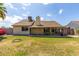 View of the spacious backyard and covered patio with dining set, perfect for outdoor entertaining at 7302 W Meadowbrook Ave, Phoenix, AZ 85033
