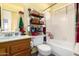 Bathroom with a single vanity, tiled shower-tub combo, and organized storage shelves at 7302 W Meadowbrook Ave, Phoenix, AZ 85033