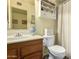 Bathroom featuring a white sink, vanity, and toilet with a shower and decor at 7302 W Meadowbrook Ave, Phoenix, AZ 85033