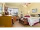 Bedroom with a cat tree near the window and a full bed, showcasing a relaxing and cozy space at 7302 W Meadowbrook Ave, Phoenix, AZ 85033