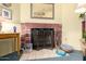 Brick fireplace with a tiled hearth and decorative items displayed nearby at 7302 W Meadowbrook Ave, Phoenix, AZ 85033