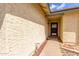 Close-up view of front door entrance, showing covered porch and desert landscaping at 7302 W Meadowbrook Ave, Phoenix, AZ 85033
