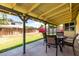 Covered patio with an outdoor dining set, offering a comfortable outdoor living space at 7302 W Meadowbrook Ave, Phoenix, AZ 85033