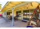 Covered patio area with outdoor furniture, adjacent to a sliding glass door to the house at 7302 W Meadowbrook Ave, Phoenix, AZ 85033