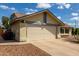 Home exterior featuring a two-car garage with desert landscaping and front yard fire hydrant at 7302 W Meadowbrook Ave, Phoenix, AZ 85033