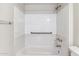 Bathroom features a tiled tub and shower with safety grab bars and updated fixtures at 750 E Northern Ave # 1089, Phoenix, AZ 85020