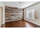 Bedroom with wood-paneled accent wall and hardwood floors at 750 E Northern Ave # 1089, Phoenix, AZ 85020