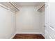 A walk-in closet with hardwood floors, painted walls, and a minimalist, functional design at 750 E Northern Ave # 1089, Phoenix, AZ 85020
