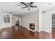 Open-concept living space with a fireplace and hardwood floors at 750 E Northern Ave # 1089, Phoenix, AZ 85020