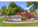 Community sign for Las Brisas Condominiums with lush landscaping and vibrant bougainvillea at 750 E Northern Ave # 1089, Phoenix, AZ 85020