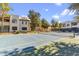Community tennis court with mature trees and clear boundary lines at 750 E Northern Ave # 1089, Phoenix, AZ 85020