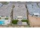 High-definition aerial view features an elegant backyard with a pool, lush landscaping, and a cozy outdoor dining area at 8021 E Jasmine St, Mesa, AZ 85207