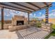 Relax in this backyard with a pergola-covered patio, brick fireplace, and lush artificial turf, perfect for outdoor entertaining at 8021 E Jasmine St, Mesa, AZ 85207