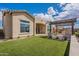 Enjoy this landscaped backyard featuring a covered patio, artificial grass, and seamless transitions to the home's living spaces at 8021 E Jasmine St, Mesa, AZ 85207