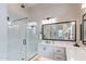 Modern bathroom featuring a glass-enclosed shower, dual vanity, and contemporary fixtures at 8021 E Jasmine St, Mesa, AZ 85207