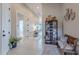 Welcoming foyer with light wood floors, decorative shelving, and bench seating at 8021 E Jasmine St, Mesa, AZ 85207