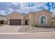 Charming single-Gathering home featuring a stone facade, arched window, and a paved driveway at 8021 E Jasmine St, Mesa, AZ 85207