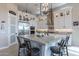 Spacious kitchen island with bar stool seating, white cabinetry, and stainless steel appliances at 8021 E Jasmine St, Mesa, AZ 85207