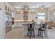 This bright kitchen features stainless steel appliances, light countertops and floors, and stylish modern lighting at 8021 E Jasmine St, Mesa, AZ 85207