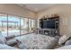 Living room with comfortable seating and seamless access to an outdoor patio area with a fireplace and barbecue at 8021 E Jasmine St, Mesa, AZ 85207