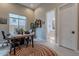 Bright home office space featuring a rustic table, neutral walls, and adjacent bathroom access at 8021 E Jasmine St, Mesa, AZ 85207