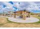 Inviting park pavilion with stone pillars, shaded seating, and lush green surroundings, perfect for outdoor gatherings at 8021 E Jasmine St, Mesa, AZ 85207