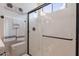 Modern shower with frameless glass enclosure and stylish fixtures, complemented by decorative wall art at 8021 E Jasmine St, Mesa, AZ 85207