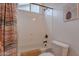 Bright and clean tub-shower combination, accented with a patterned curtain and soft lighting at 8021 E Jasmine St, Mesa, AZ 85207