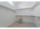 Walk-in closet featuring built-in shelving and ample storage space at 8021 E Jasmine St, Mesa, AZ 85207