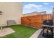 Outdoor oasis featuring artificial turf, a BBQ grill, and privacy fence with butterfly decor at 8043 W Albeniz Pl, Phoenix, AZ 85043