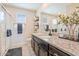 This is a bathroom with granite countertops, dark cabinets, a sink, and a toilet at 8043 W Albeniz Pl, Phoenix, AZ 85043