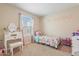 This bedroom contains carpet, curtains, a bed, and a vanity at 8043 W Albeniz Pl, Phoenix, AZ 85043