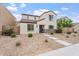 Charming two-story home featuring stone accents, low-maintenance landscaping, and a inviting blue front door at 8043 W Albeniz Pl, Phoenix, AZ 85043