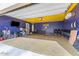 This spacious garage has ample room for storage, a TV, and recreational vehicles at 8043 W Albeniz Pl, Phoenix, AZ 85043