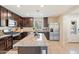 Well-equipped kitchen featuring dark wood cabinets, granite countertops, and stainless steel appliances at 8043 W Albeniz Pl, Phoenix, AZ 85043