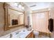 Well-lit bathroom with decorative mirror, a light wood vanity, and neutral patterned shower curtain at 8242 S Kachina Dr, Tempe, AZ 85284