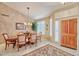 Elegant dining room featuring wood floors, a chandelier, and natural light with views of the front yard at 8242 S Kachina Dr, Tempe, AZ 85284