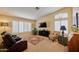 Cozy living room with plush seating, a vaulted ceiling, a ceiling fan, and plantation shutters at 8242 S Kachina Dr, Tempe, AZ 85284
