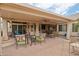Expansive covered patio with stylish outdoor seating and a view of the lush landscaping at 8242 S Kachina Dr, Tempe, AZ 85284