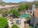 Backyard oasis with sparkling pool, lush landscaping, outdoor kitchen, and fire pit at 8540 E Mcdowell Rd # 10, Mesa, AZ 85207