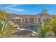 Backyard features a private pool, tile roof, manicured plants, covered patio, and desert landscaping at 8540 E Mcdowell Rd # 10, Mesa, AZ 85207