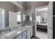 Bathroom with granite countertops, double sinks, modern vanity, and views into the main bedroom at 8540 E Mcdowell Rd # 10, Mesa, AZ 85207