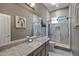 Bathroom features a granite vanity, an enclosed shower with a glass door, and modern fixtures at 8540 E Mcdowell Rd # 10, Mesa, AZ 85207