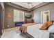 Cozy bedroom features an electric fireplace, stylish furnishings, and a mounted television at 8540 E Mcdowell Rd # 10, Mesa, AZ 85207