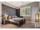 Stylish bedroom design with textured wall accent, comfortable carpeting and neutral color palette at 8540 E Mcdowell Rd # 10, Mesa, AZ 85207