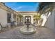 Beautiful courtyard featuring a fountain, seating area, and covered walkway, a serene outdoor oasis at 8540 E Mcdowell Rd # 10, Mesa, AZ 85207