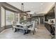 Bright dining area features a farmhouse table and chairs, tiled flooring, and a large window at 8540 E Mcdowell Rd # 10, Mesa, AZ 85207