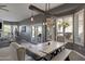 Open dining room boasts a rustic wood table with bench seating and modern lighting fixtures at 8540 E Mcdowell Rd # 10, Mesa, AZ 85207