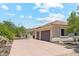 Detached garage with a paver driveway and a home featuring a tiled roof and desert landscaping at 8540 E Mcdowell Rd # 10, Mesa, AZ 85207